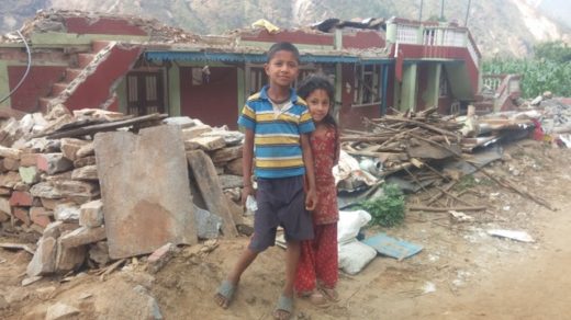 Bro and sis in front of their house